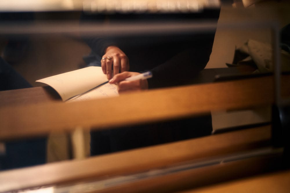 Hands writing in a notebook